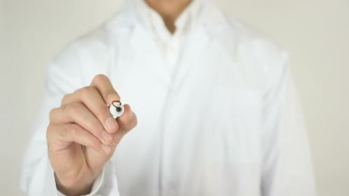 Doctor Writing "STOP HIV" Message on Glass