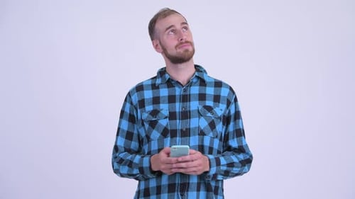 Young Adult Thinks While Holding Cell Phone