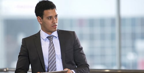 Man in Suit Using Tablet in Modern Office