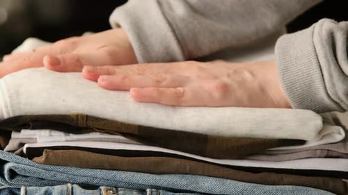 Stack clothing for sorting and baggage packing. Clothes for donation or shopping concept.