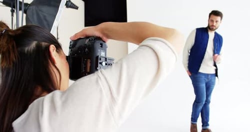 Photographer Taking Pictures of Model in Studio