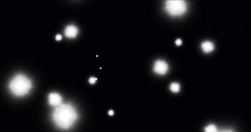 Animation von leuchtenden weißen Lichtflecken, die sich in hypnotischer Bewegung auf schwarzem Hintergrund bewegen