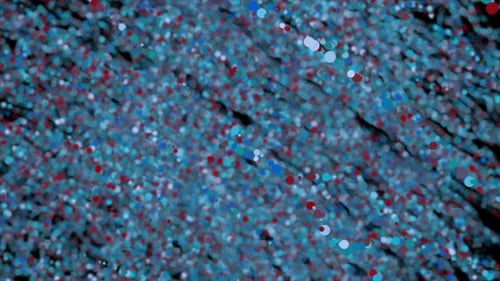 Chaînes de particules multicolores floues se déplaçant lentement sur fond noir