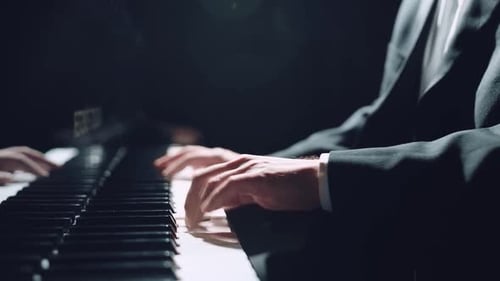 Close Up of Hands Playing Grand Piano