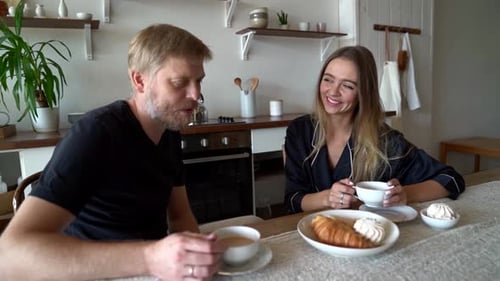 Couple Enjoying Breakfast Together in Bright Kitchen