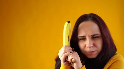 Young Woman with Banana in Studio Setting