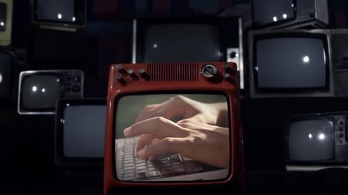 Hands Type on Keyboard Seen on Retro TV