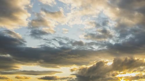 Zeitraffer von sich schnell bewegenden Wolken am dunkelblauen Himmel bei Sonnenuntergang.