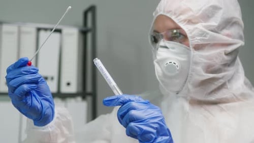 PCR Test in Laboratory Doctor Holding COVID19 Coronavirus Swab Collection Kit Wearing PPE Protective
