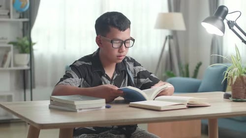 Teen Reading a Book at a Desk