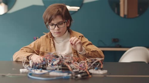 Portrait of School Kid Constructing Robot