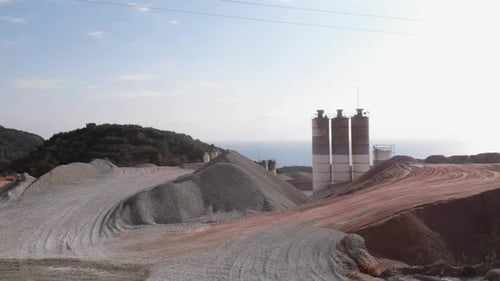 High towers at concrete plant structure. Industrial production area of concrete cement factory.