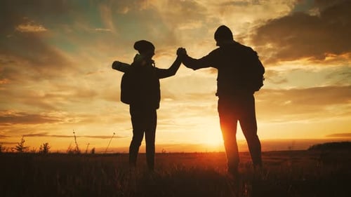 Silhouette of the Team on the Peak of Mountain. Sport and Active Life of People Man and Girl