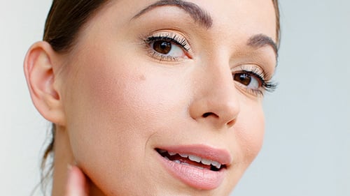 Woman Massaging Face in Beauty Treatment Close-Up