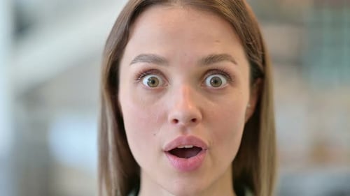 Close Up of Shocked of Young Woman Looking at the Camera