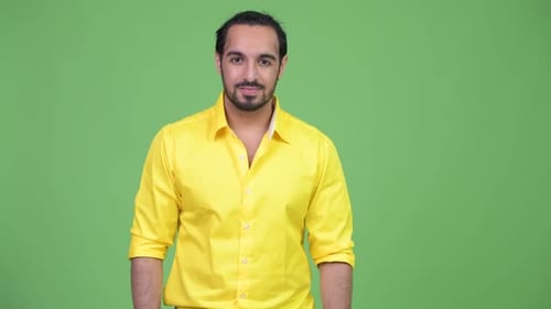 Young Handsome Bearded Indian Businessman Looking Surprised
