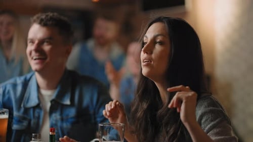 Friends Watching TV Drinking Beer and Supporting Team at Bar