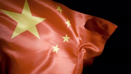 Chinese Flag Waving Against Dark Background