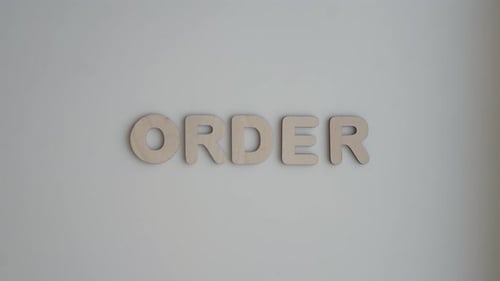 Wooden Letters Spelling Order on White Surface