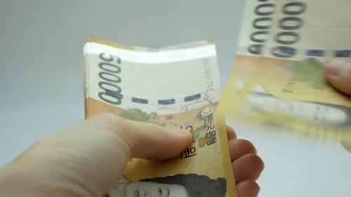 Hands Counting Stack of 50000 Currency Notes