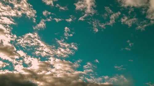 Clouds Pass By in Blue Sunny Sky