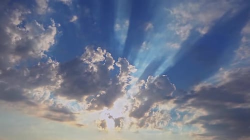 Sun Rays Radiating Through Clouds in Sky