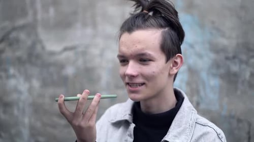 Young Adult Sending Voice Message on Phone