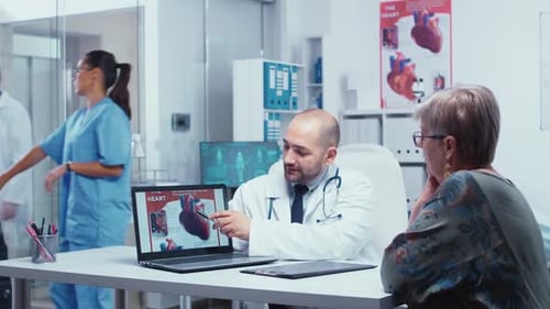 Doctor Explains Heart Diagram to Senior Woman