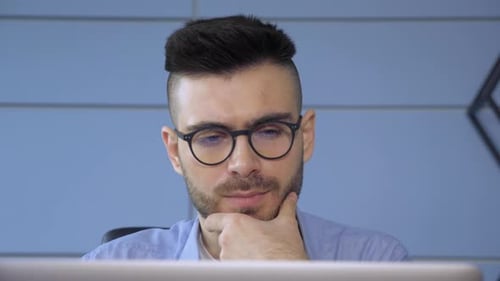 Close Up of A Young European Man with Glasses, Modern Guy Surfing Internet Use Laptop pc in Home