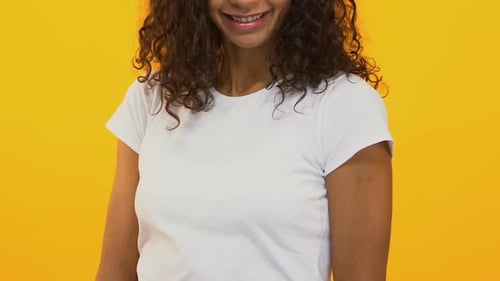 Woman Holding a Red Paper Heart Smiling