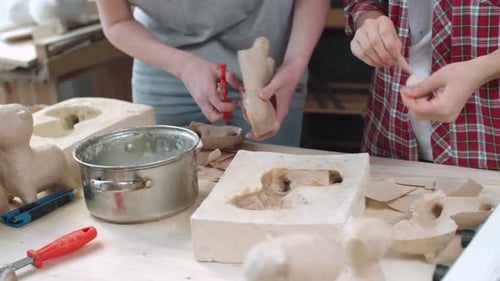 Women Crafting Paper Mache Figures in Studio