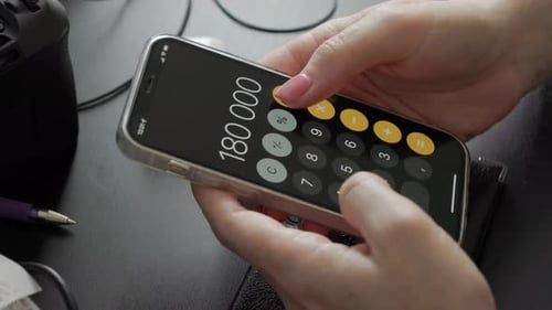 Hands Using Smartphone Calculator App