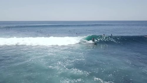 A Young Male Surfer Riding a Barreling Wave Trying To Balance on the Surf Board.