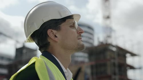 Engineer in Safety Helmet Standing on Construction Site