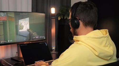 Man Playing First-Person Shooter Game on Computer