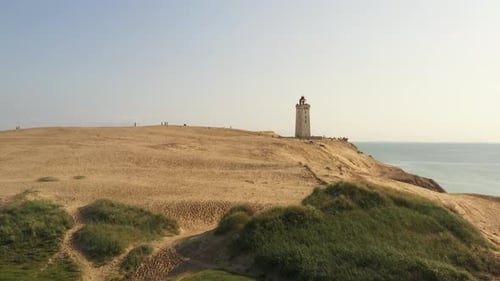 Picturesque Lighthouse on Sandy Coastline Aerial
