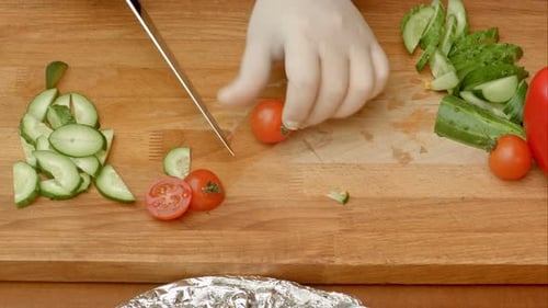 Vegetables Being Sliced on a Wooden Cutting Board