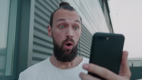 Man with Beard Reacts to Phone