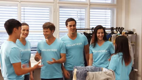 Enthusiastic Volunteers Standing Together Indoors