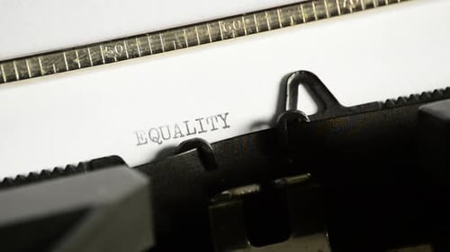 Typewriter Types the Word "Equality" on Paper