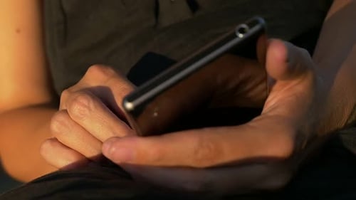 Hands Holding Mobile Device Close Up