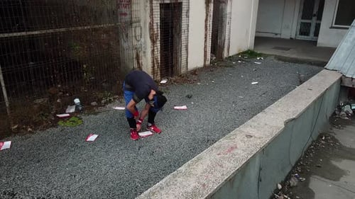 Man Jumps Over Wall in Urban Environment