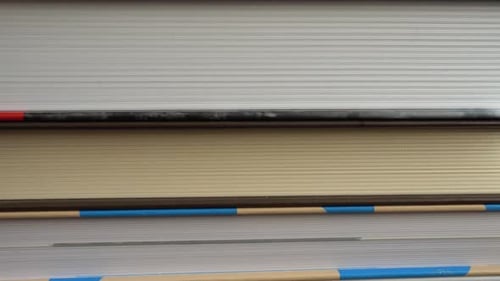 Stack of Well-Loved Books Resting Horizontally