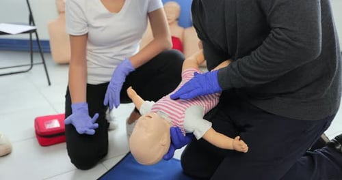 Infant CPR Instruction with Doll in Healthcare Setting