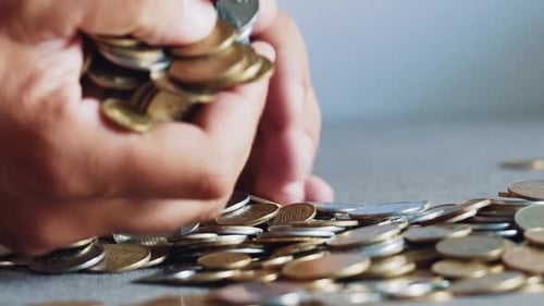 Close Up of Hand with Gold Coins