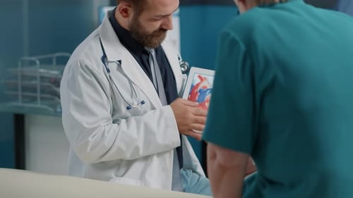 Doctor Explains Heart Anatomy Using Tablet in Hospital