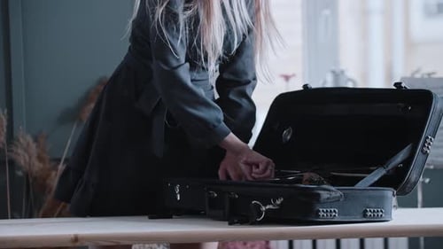 Woman Removes Violin From Case Indoors