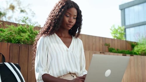 Young Black Woman University Student Learning Online Using Laptop Outdoor