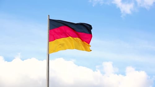 German Flag Waving Against Blue Sky
