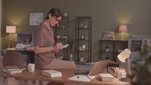 Mid-Adult Woman Studying on Laptop from Home